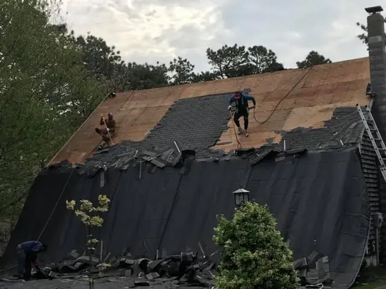 Crew re-roofing a Cape Cod home