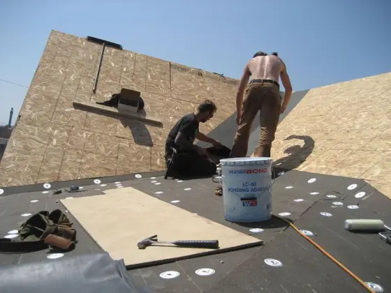 Crew installing roofing underlayment