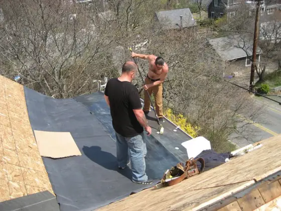 Roofers working on fresh underlayment